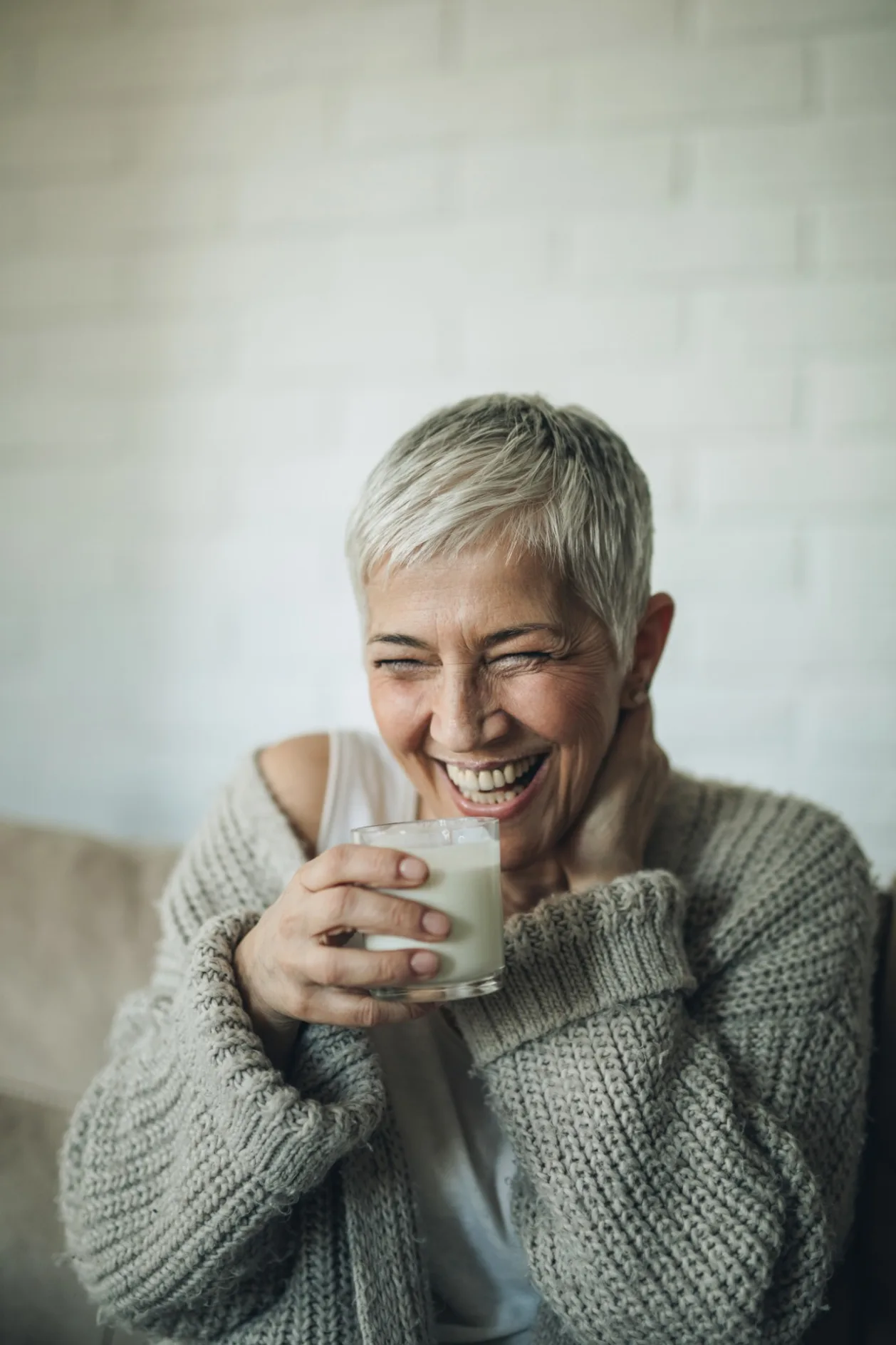 cheerful mature woman drinking milk